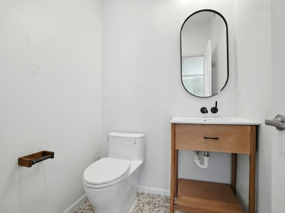 Bathroom with Pebble Floor and Black Faucet