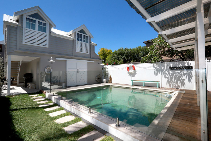 This is an example of a beach style backyard pool in Sydney.