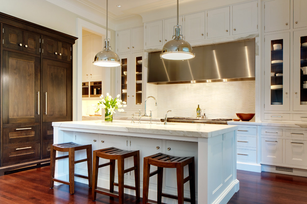 Inspiration for a large transitional galley dark wood floor eat-in kitchen remodel in Chicago with an undermount sink, white cabinets, marble countertops, white backsplash, mosaic tile backsplash, paneled appliances, an island and recessed-panel cabinets