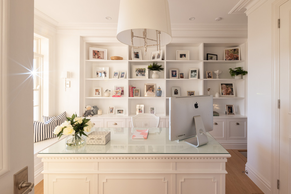 Photo of a mid-sized traditional home office in Brisbane with white walls, light hardwood floors and a freestanding desk.