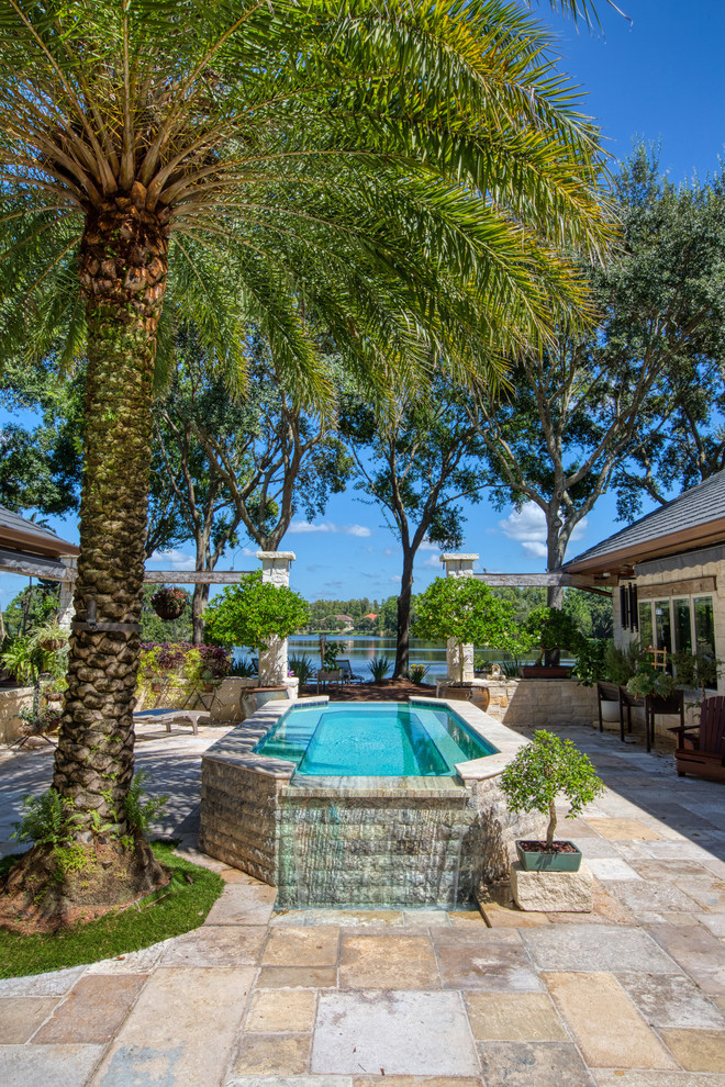 Photo of a tropical courtyard rectangular lap pool in Tampa with tile.