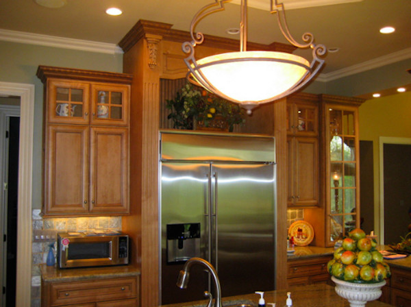 Inspiration for an eat-in kitchen remodel in Louisville with recessed-panel cabinets, light wood cabinets and stainless steel appliances