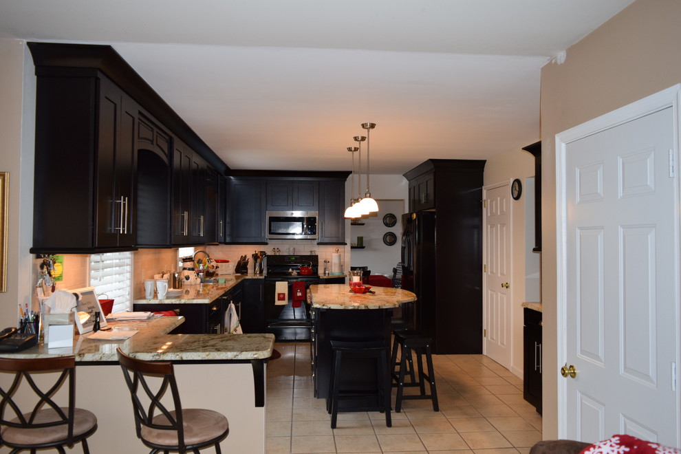 Inspiration for a transitional u-shaped ceramic tile kitchen remodel with an undermount sink, shaker cabinets, dark wood cabinets, quartz countertops, beige backsplash, subway tile backsplash, black appliances and an island