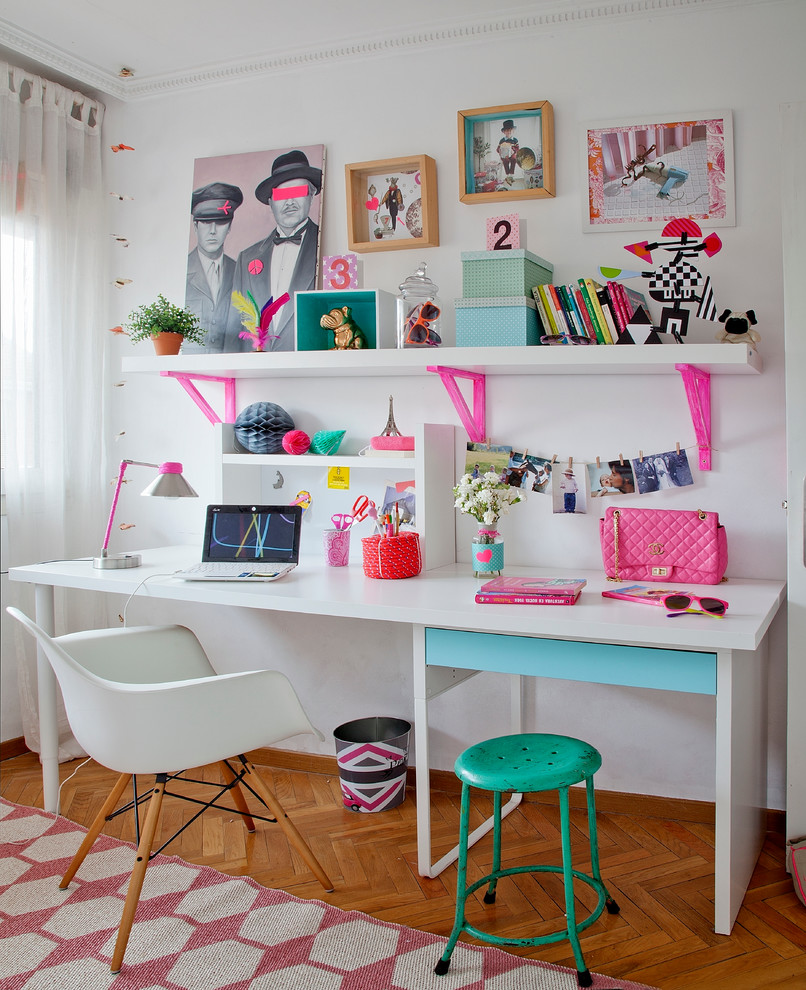 Photo of a mid-sized scandinavian kids' room for girls in Madrid with white walls and medium hardwood floors.