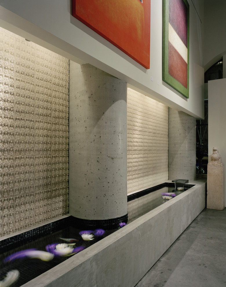 This is an example of a modern entryway in Seattle with concrete floors.