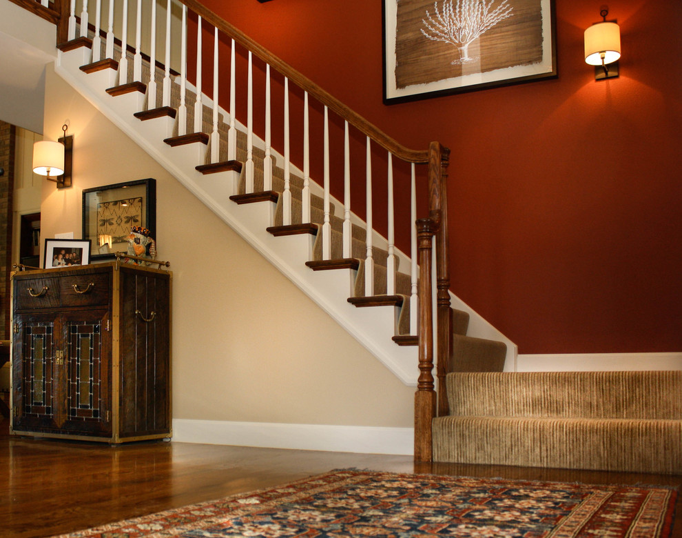 Photo of a traditional carpeted straight staircase in Denver with carpet risers.