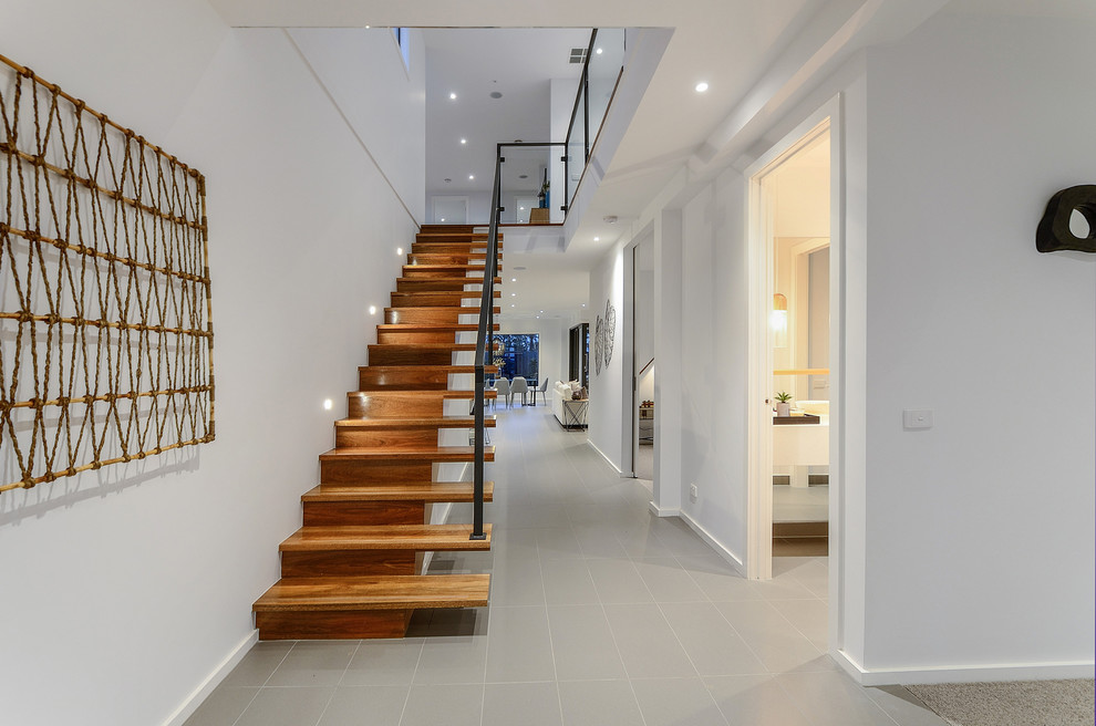 Design ideas for a mid-sized contemporary wood straight staircase in Melbourne with wood risers.