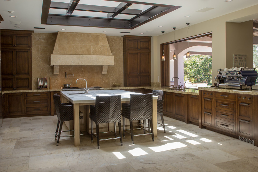 Photo of a country u-shaped eat-in kitchen in San Diego with an undermount sink, recessed-panel cabinets, medium wood cabinets, marble benchtops, beige splashback, stone tile splashback and panelled appliances.