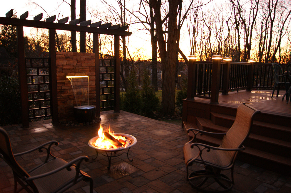 Design ideas for an expansive contemporary backyard deck in New York with a fire feature and a pergola.