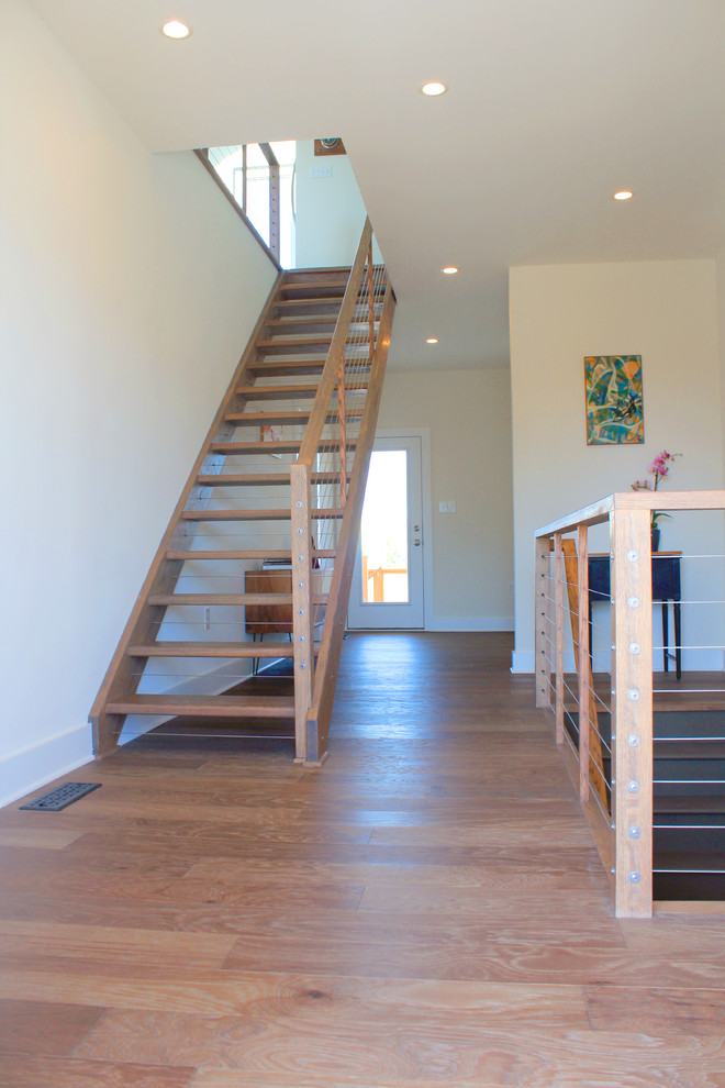 Large beach style wood straight staircase in Philadelphia with open risers.