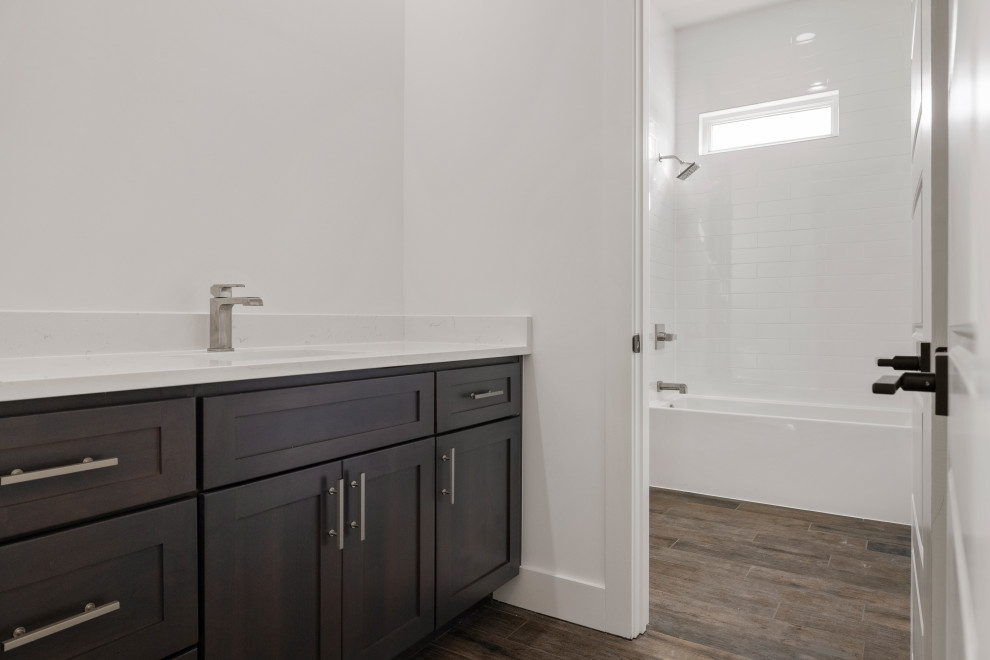 Inspiration for a contemporary bathroom in Austin with shaker cabinets, brown cabinets, an alcove shower, a one-piece toilet, wood-look tile, an undermount sink, granite benchtops, white benchtops, a single vanity and a built-in vanity.