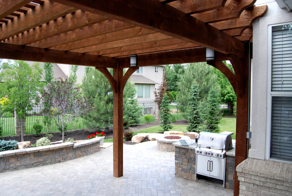Photo of a traditional patio in Salt Lake City with a fire feature and a pergola.