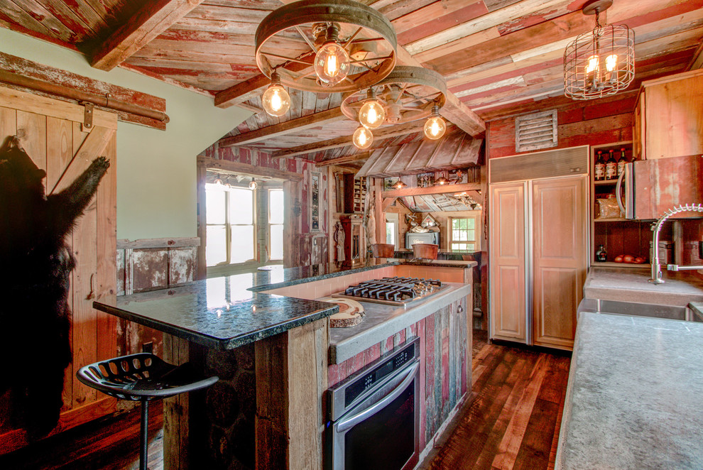 Inspiration for a small rustic galley medium tone wood floor eat-in kitchen remodel in Milwaukee with recessed-panel cabinets, light wood cabinets, an island, a farmhouse sink, concrete countertops, beige backsplash, ceramic backsplash and stainless steel appliances