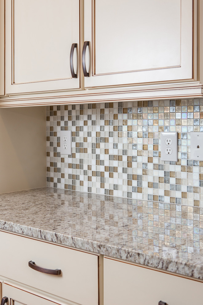 Eat-in kitchen - mid-sized contemporary galley medium tone wood floor eat-in kitchen idea in Atlanta with a double-bowl sink, beaded inset cabinets, beige cabinets, granite countertops, beige backsplash, mosaic tile backsplash, stainless steel appliances and an island