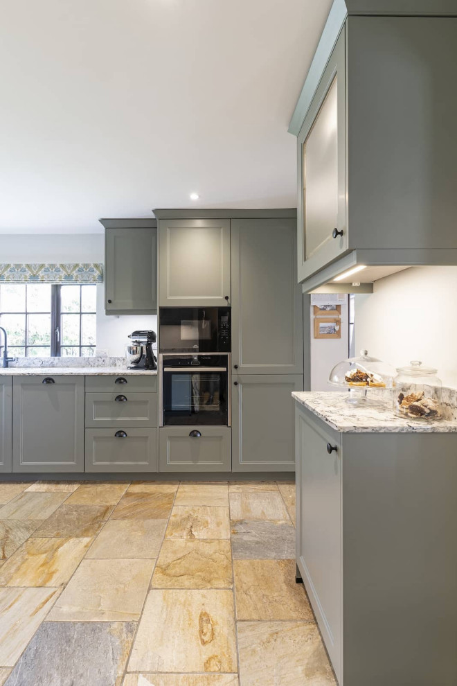 Inspiration for a large country u-shaped enclosed kitchen in Buckinghamshire with shaker cabinets, black cabinets, quartz worktops, black appliances and terracotta flooring.