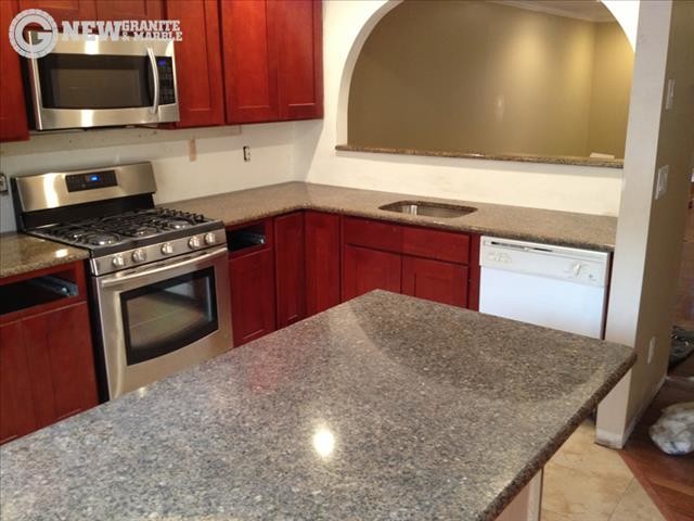Inspiration for a mid-sized timeless medium tone wood floor kitchen remodel in New York with medium tone wood cabinets and granite countertops