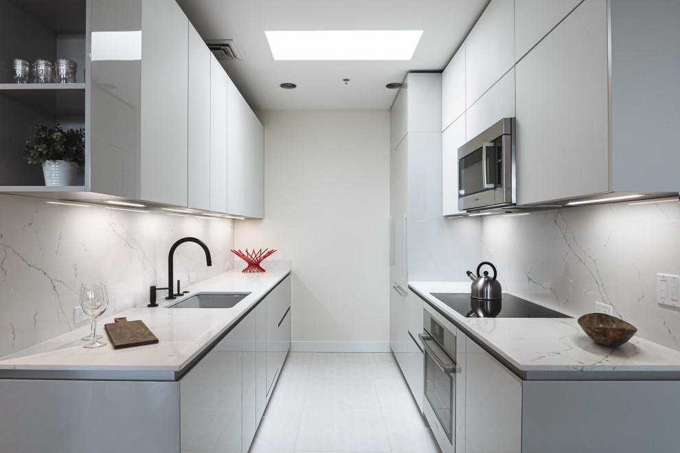 This is an example of a mid-sized modern galley eat-in kitchen in Portland with an undermount sink, flat-panel cabinets, grey cabinets, quartz benchtops, white splashback, engineered quartz splashback, panelled appliances, ceramic floors, no island, white floor and white benchtop.