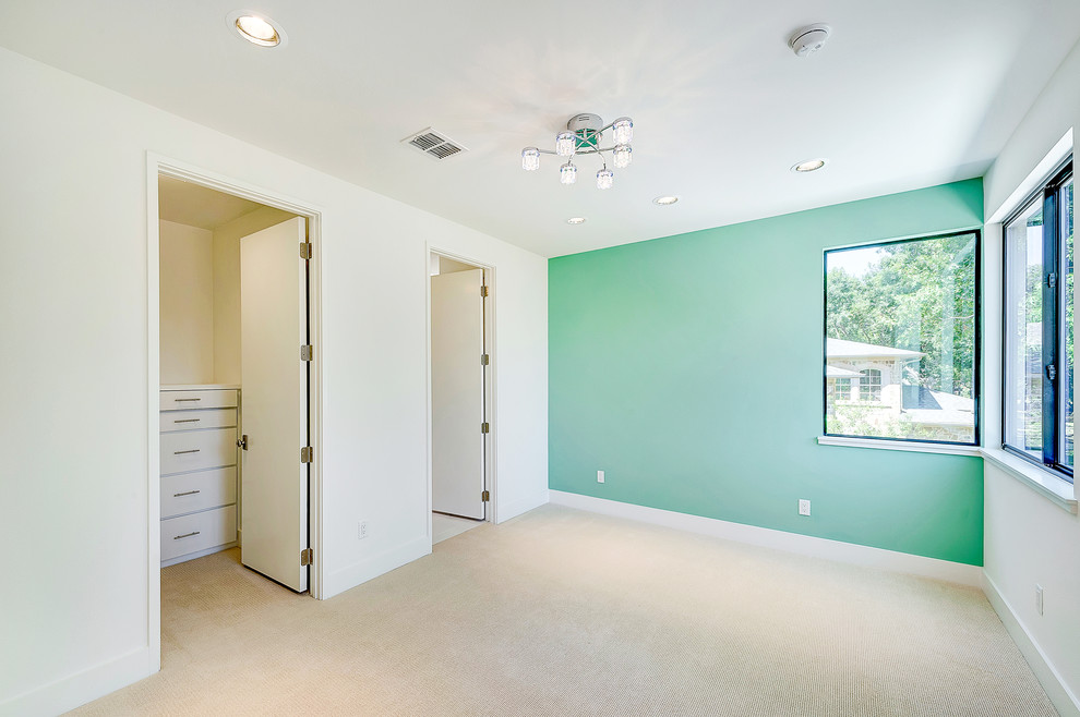 Photo of a modern bedroom in Dallas with green walls and carpet.