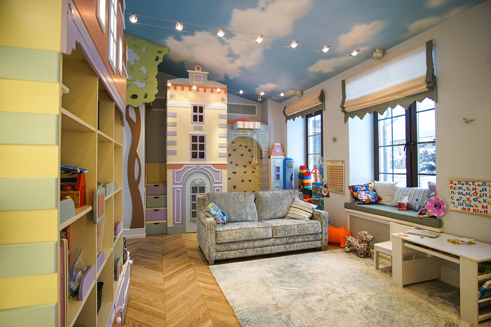Design ideas for a traditional gender-neutral kids' playroom for kids 4-10 years old in Moscow with white walls and light hardwood floors.