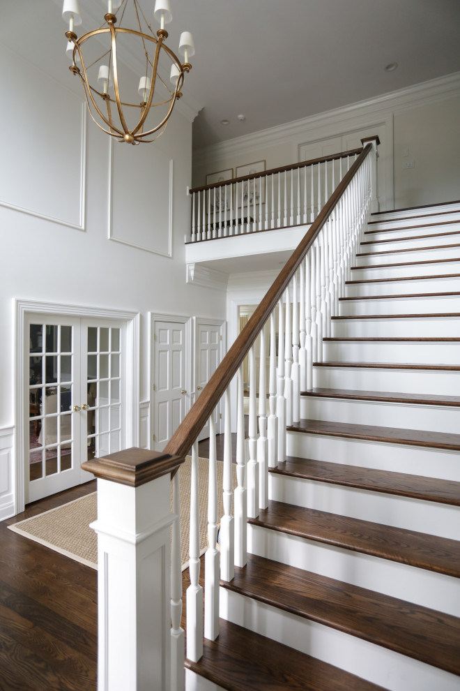 Design ideas for a large transitional staircase in Indianapolis with decorative wall panelling.