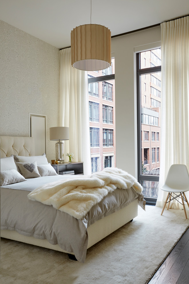 Transitional master bedroom in New York with beige walls, dark hardwood floors and brown floor.