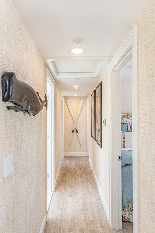 Mid-sized beach style hallway in Boston with beige walls, light hardwood floors and beige floor.