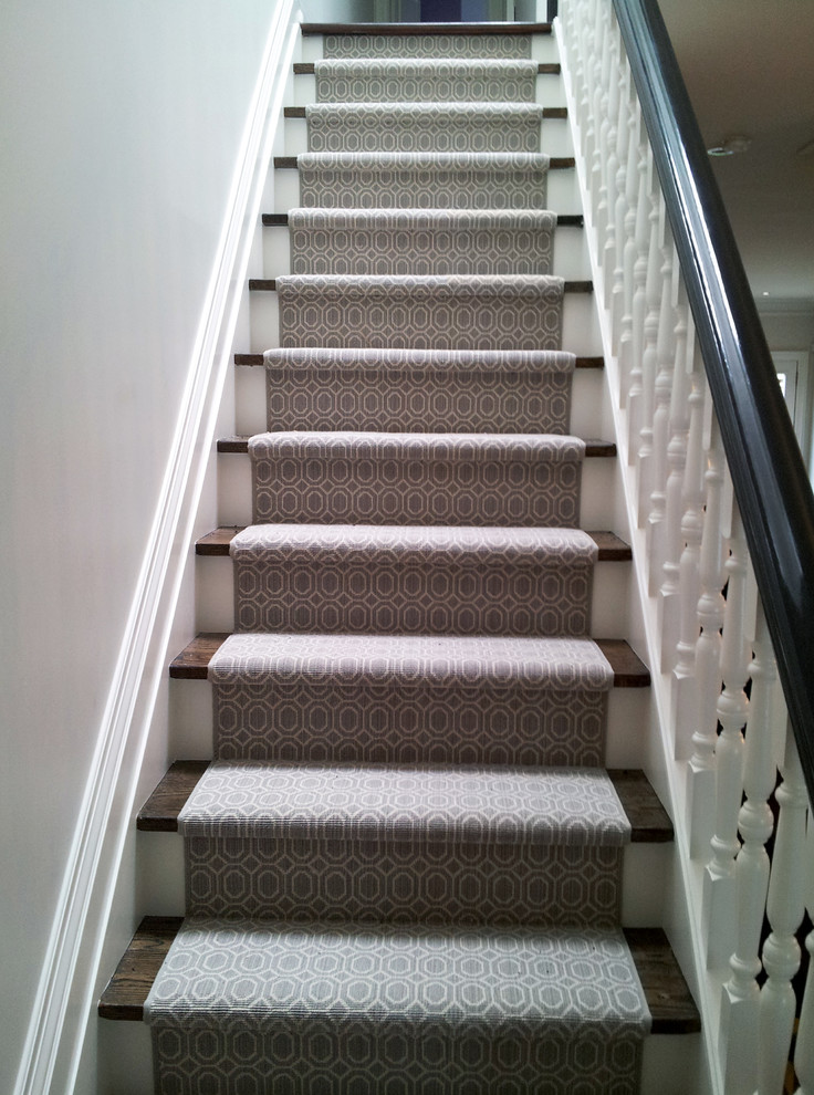 Design ideas for a small eclectic carpeted straight staircase in Toronto with carpet risers.