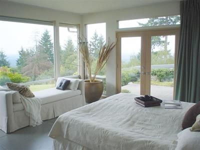 Natural light pours through large windows in this master bedroom.