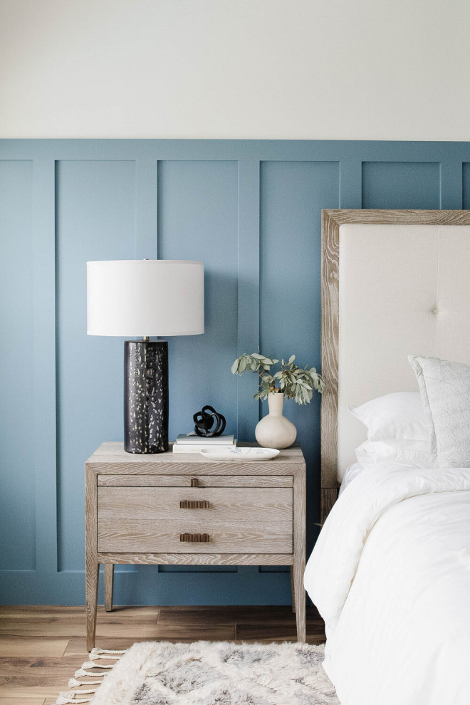 Design ideas for a large beach style master bedroom in Other with blue walls and decorative wall panelling.