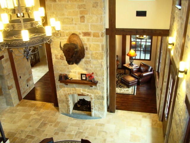 Photo of a country living room in Austin with travertine floors.