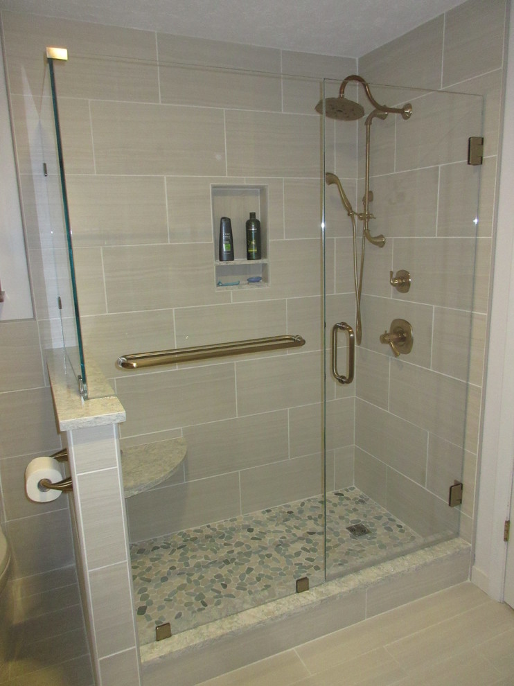 Double shower - mid-sized transitional master beige tile and porcelain tile porcelain tile double shower idea with flat-panel cabinets, medium tone wood cabinets, a two-piece toilet, gray walls, a vessel sink and quartz countertops