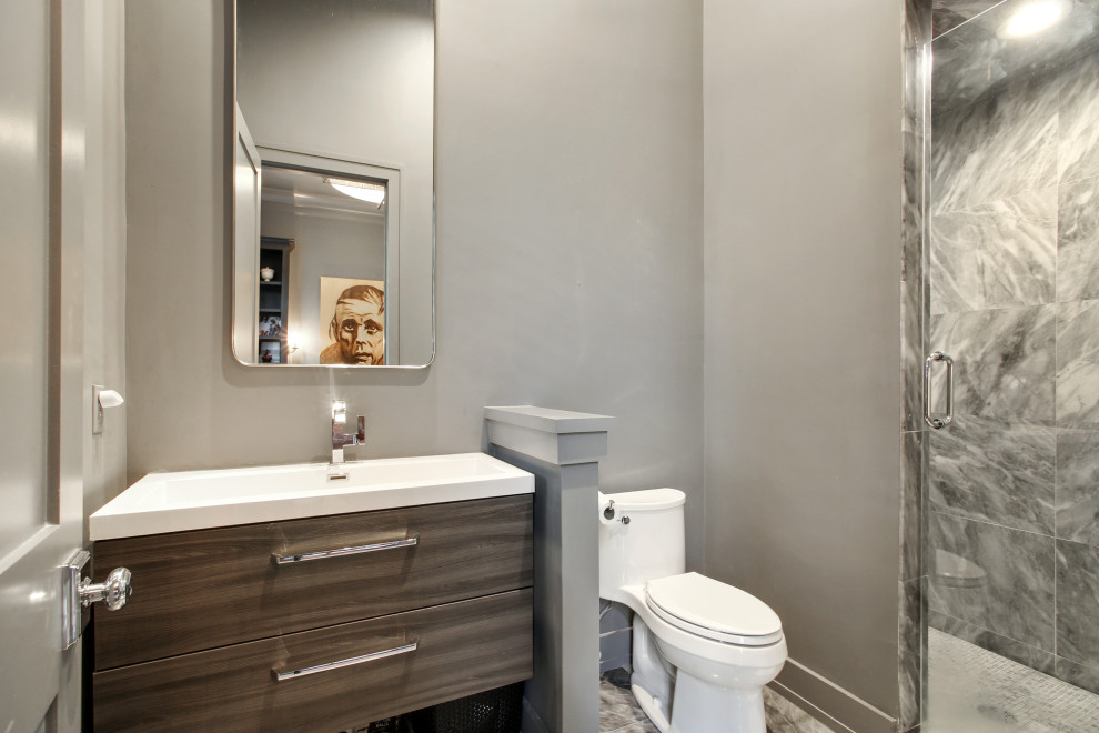 Photo of a small transitional bathroom in New Orleans with flat-panel cabinets, dark wood cabinets, a freestanding tub, an alcove shower, a two-piece toilet, white tile, porcelain tile, white walls, marble floors, a vessel sink, wood benchtops, white floor, a hinged shower door, brown benchtops, a single vanity, a floating vanity and vaulted.