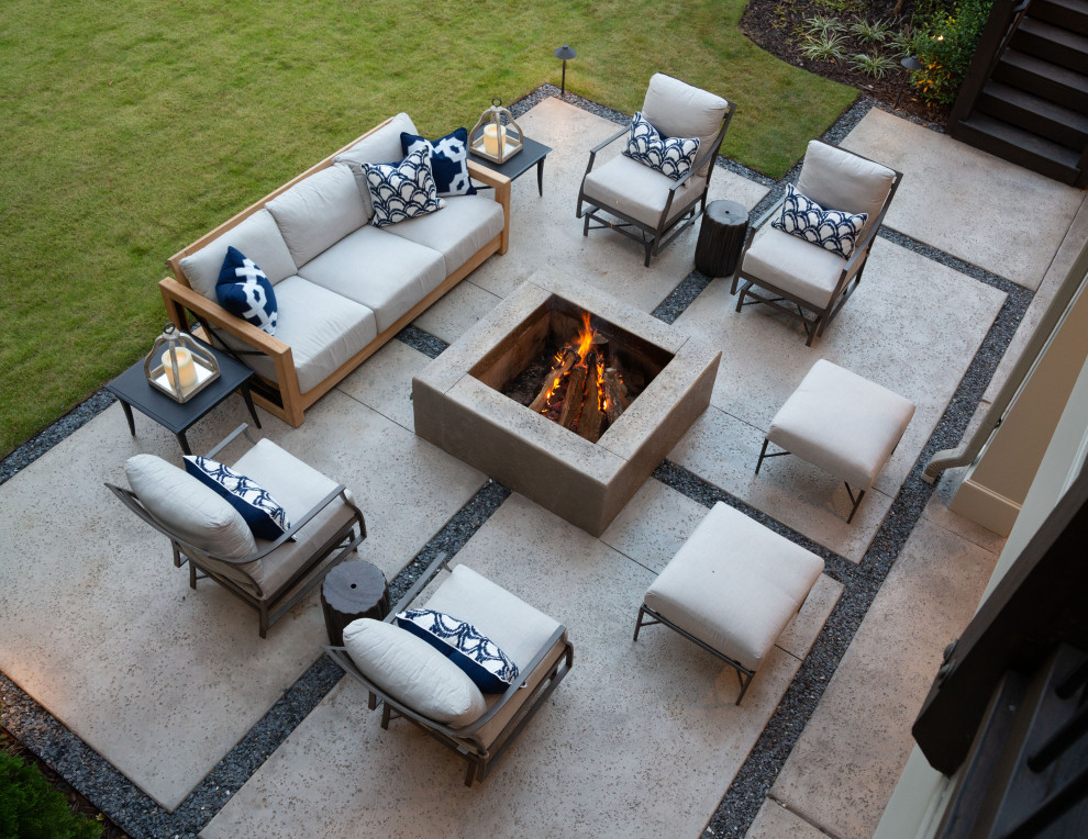 This is an example of a mid-sized transitional backyard patio in Atlanta with a fire feature, concrete slab and no cover.