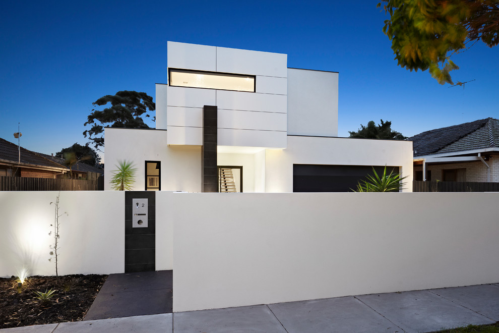 Photo of a large contemporary two-storey white house exterior in Melbourne with mixed siding, a flat roof and a metal roof.