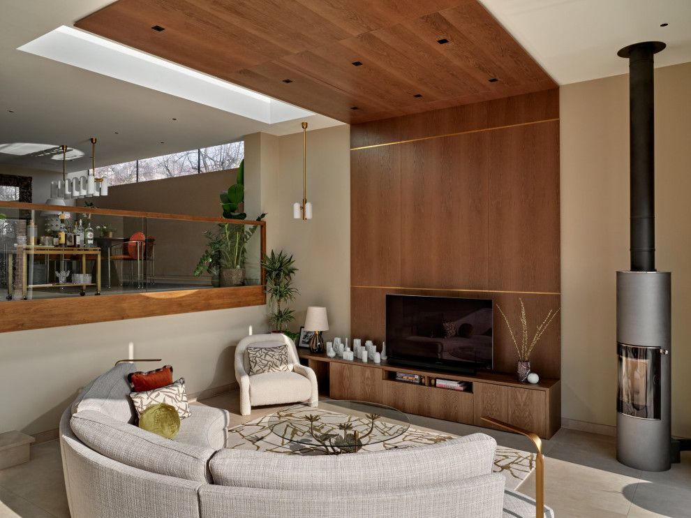 Photo of a large contemporary formal mezzanine living room feature wall in London with beige walls, ceramic flooring, a metal fireplace surround, a freestanding tv, beige floors, a wood ceiling and panelled walls.
