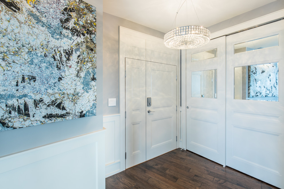 Transitional foyer in Vancouver with grey walls, medium hardwood floors, a white front door and brown floor.