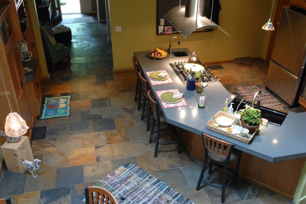 Open concept kitchen - large transitional l-shaped slate floor and multicolored floor open concept kitchen idea with an undermount sink, shaker cabinets, medium tone wood cabinets, quartz countertops, stainless steel appliances, an island and gray countertops