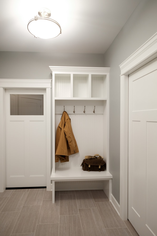 Photo of a small arts and crafts mudroom in Detroit with ceramic floors, a single front door, a white front door, beige floor and grey walls.
