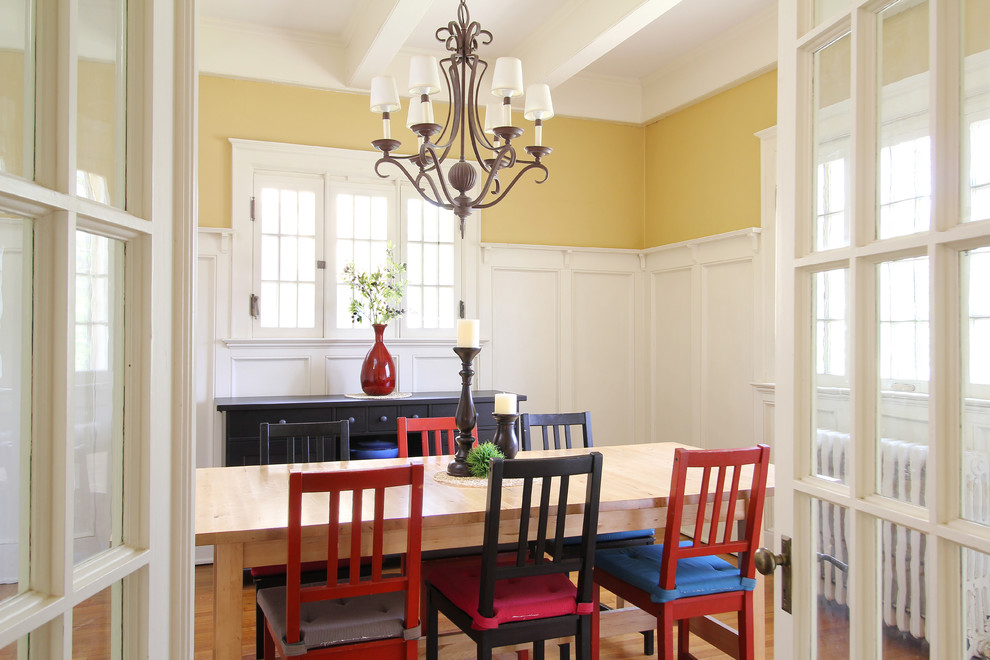 Design ideas for a traditional separate dining room in Grand Rapids with yellow walls and medium hardwood floors.
