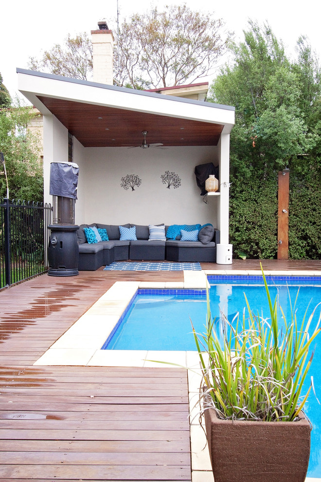 Contemporary backyard pool in Melbourne with decking.