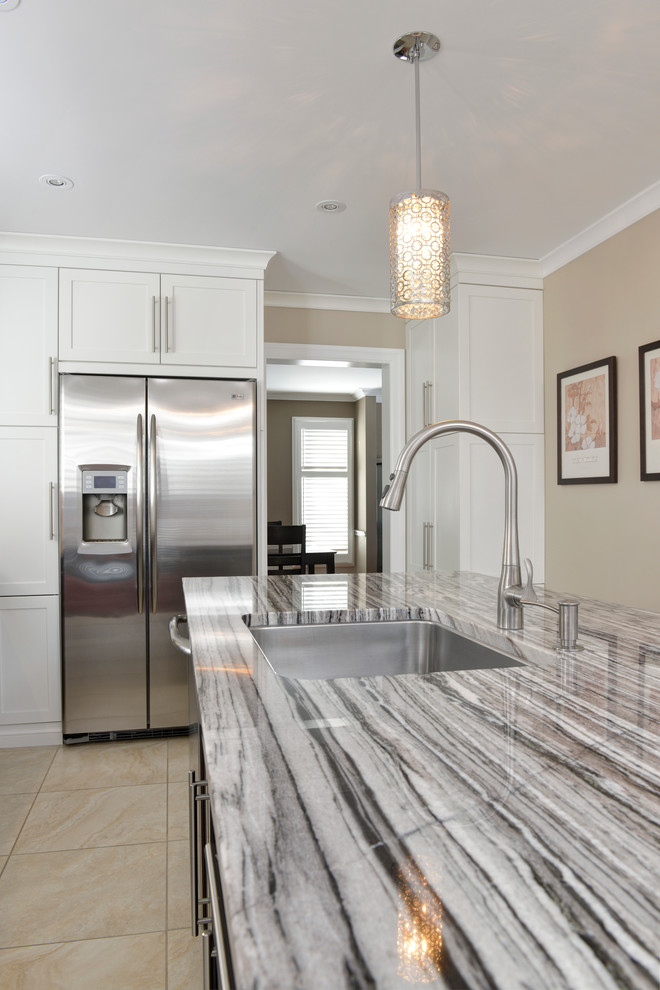 Inspiration for a large transitional u-shaped ceramic tile enclosed kitchen remodel in Toronto with an undermount sink, flat-panel cabinets, dark wood cabinets, granite countertops, beige backsplash, matchstick tile backsplash, stainless steel appliances and an island