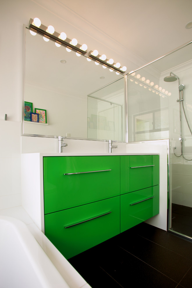 Photo of a small transitional kids bathroom in Perth with an undermount sink, flat-panel cabinets, green cabinets, engineered quartz benchtops, a drop-in tub, a corner shower, white tile, porcelain tile, white walls and porcelain floors.