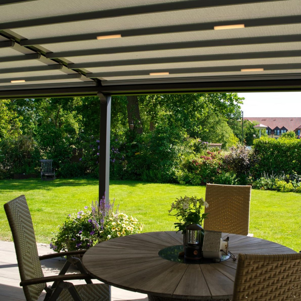 Modelo de terraza planta baja contemporánea de tamaño medio en patio lateral con privacidad y pérgola