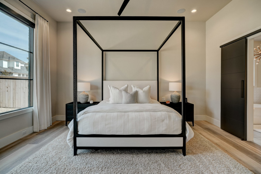 Ejemplo de dormitorio principal minimalista de tamaño medio con suelo vinílico, todas las chimeneas y marco de chimenea de yeso