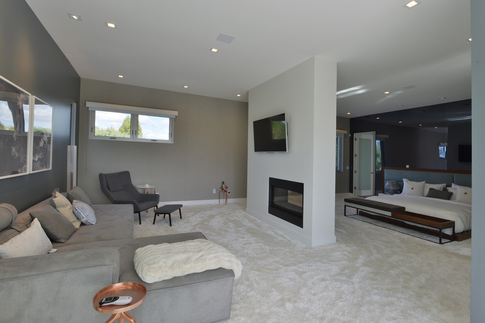 Design ideas for a large modern master bedroom in Los Angeles with grey walls, carpet, a standard fireplace and a metal fireplace surround.
