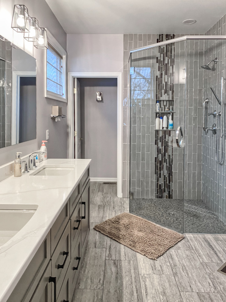 This is an example of a medium sized traditional ensuite bathroom in Chicago with recessed-panel cabinets, grey cabinets, a built-in shower, grey tiles, metro tiles, grey walls, vinyl flooring, quartz worktops, grey floors, a hinged door, white worktops, a wall niche, double sinks and a built in vanity unit.