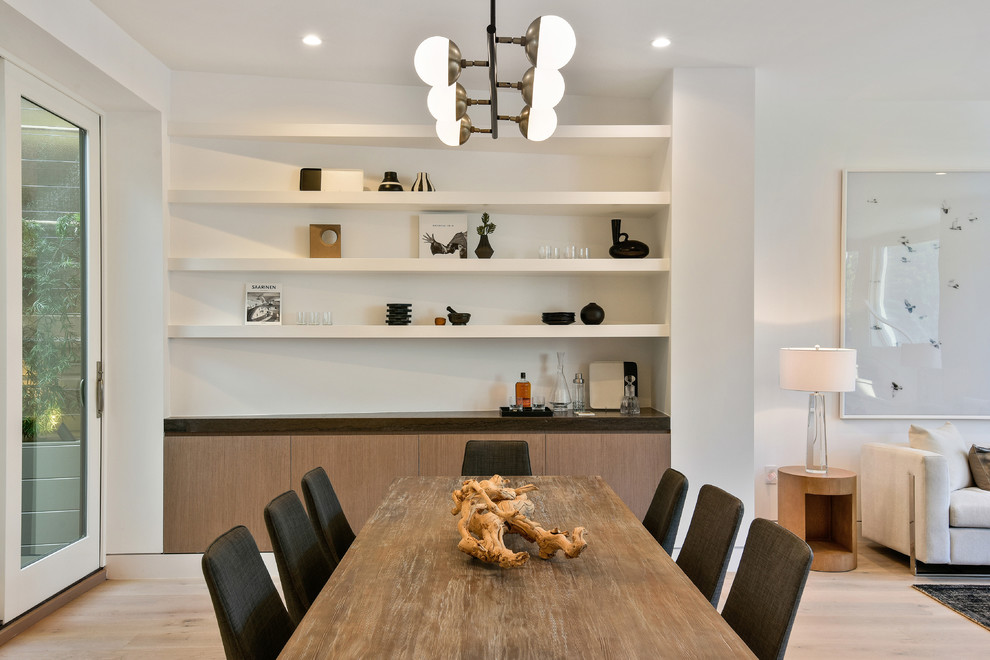 Design ideas for a contemporary open plan dining in San Francisco with white walls, light hardwood floors and beige floor.