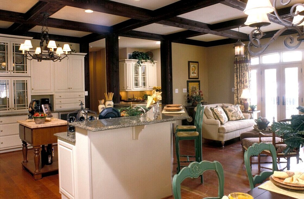 Inspiration for a mid-sized transitional l-shaped medium tone wood floor and brown floor eat-in kitchen remodel in Baltimore with white cabinets, an island, raised-panel cabinets and granite countertops