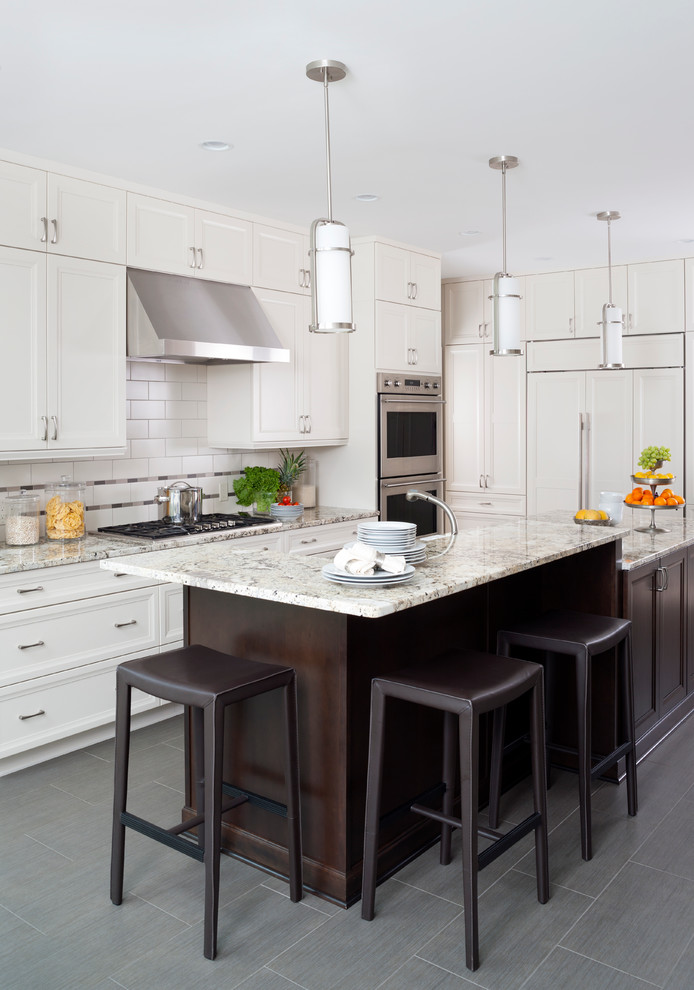 Example of a large transitional u-shaped ceramic tile enclosed kitchen design in Baltimore with a single-bowl sink, recessed-panel cabinets, white cabinets, granite countertops, white backsplash, subway tile backsplash, stainless steel appliances and an island