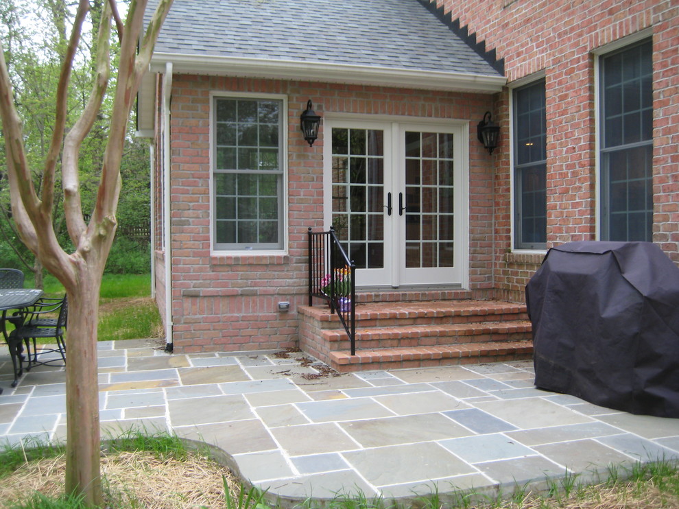 Inspiration for a traditional backyard patio in Baltimore with tile and no cover.